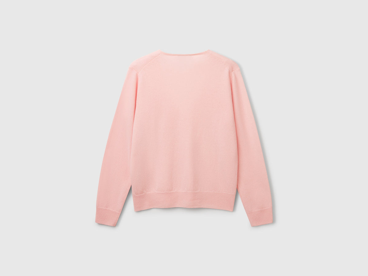Maglione rosa cipria con scollo a V in pura lana Merino